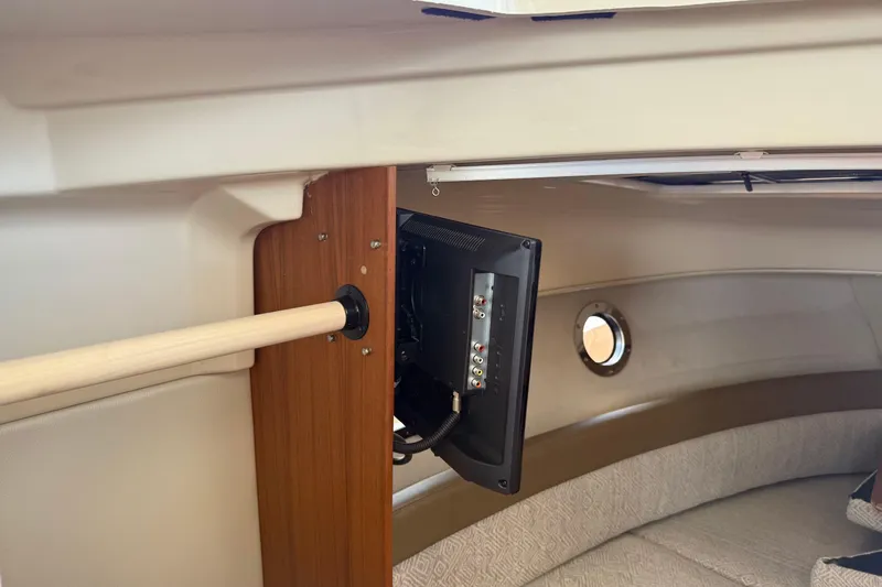  Yacht Photos Pics 2024 Ranger Tugs R-25 interior with mounted TV and porthole view.