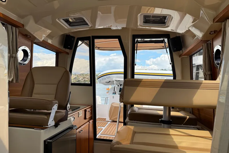  Yacht Photos Pics Interior of 2024 Ranger Tugs R-25 boat with seating and water view.