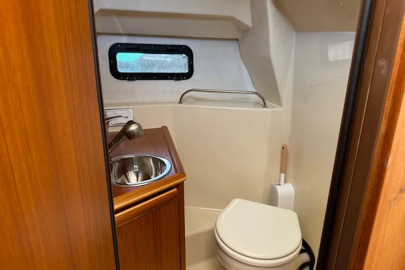  Yacht Photos Pics 2024 Ranger Tugs R-25 boat bathroom with sink, toilet, and window.