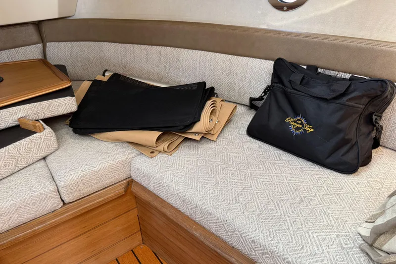  Yacht Photos Pics 2024 Ranger Tugs R-25 interior with seating, storage bag, and folded covers.