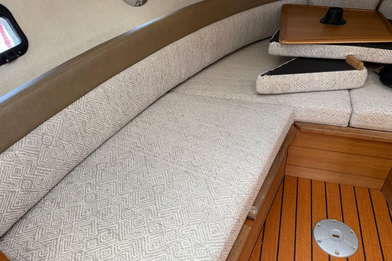  Yacht Photos Pics 2024 Ranger Tugs R-25 interior with patterned seating and wooden flooring.