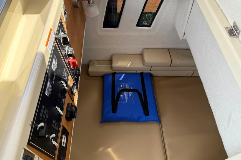  Yacht Photos Pics 2024 Ranger Tugs R-25 cabin interior with control panel and seating area.