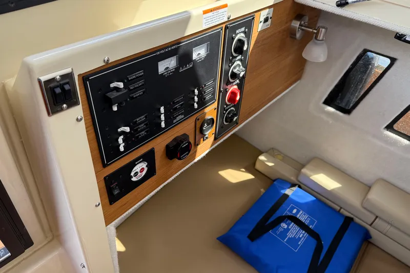  Yacht Photos Pics 2024 Ranger Tugs R-25 interior control panel with seating and blue bag.