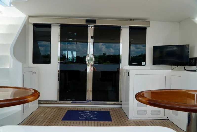 Miss Patti Yacht Photos Pics Ocean Alexander 74 Motoryacht 2008 interior with sliding glass doors and wooden tables.
