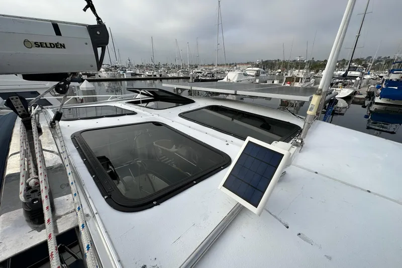 Dasananas Yacht Photos Pics 2008 Hunter 49 sailboat with solar panel, docked in marina, overcast sky.