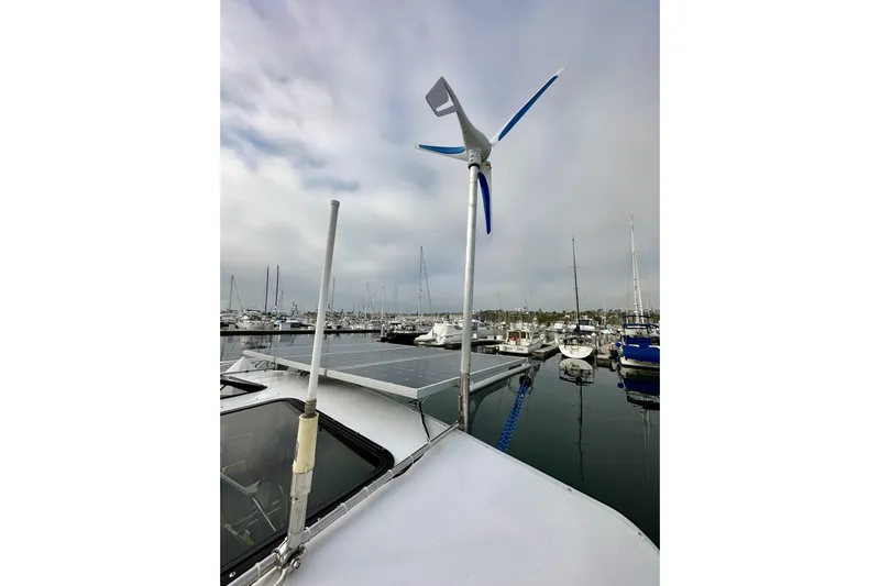 Dasananas Yacht Photos Pics Hunter 49 sailboat (2008) with wind turbine and solar panels in marina.