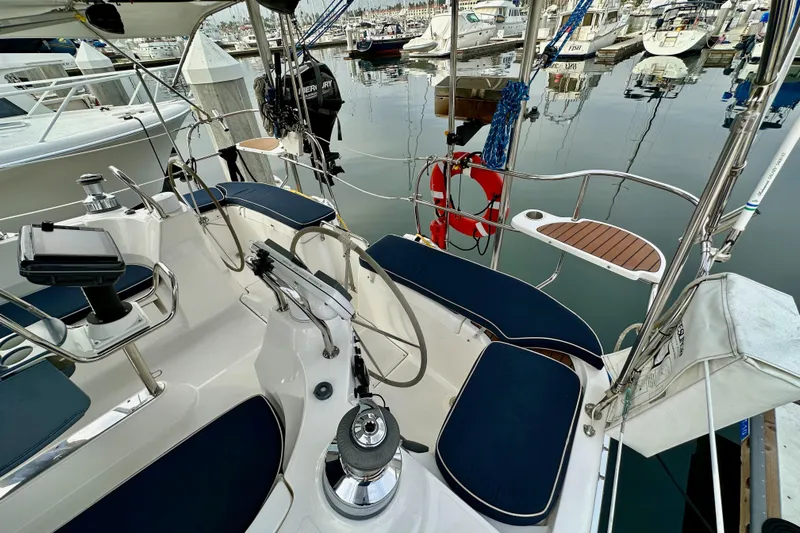 Dasananas Yacht Photos Pics Cockpit of 2008 Hunter 49 sailboat docked in marina, featuring blue seating and equipment.