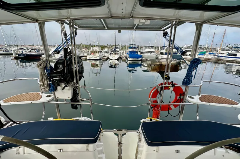 Dasananas Yacht Photos Pics 2008 Hunter 49 yacht docked in marina, surrounded by boats and calm water.