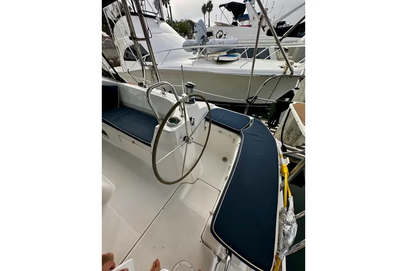 Dasananas Yacht Photos Pics 2008 Hunter 49 sailboat cockpit with steering wheel and blue seating at marina.