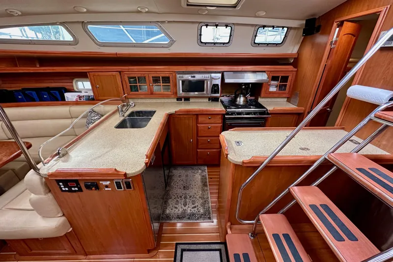 Dasananas Yacht Photos Pics Luxurious 2008 Hunter 49 yacht interior with modern kitchen and wooden cabinetry.