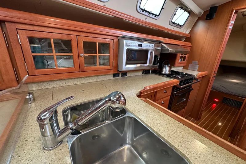 Dasananas Yacht Photos Pics Luxurious 2008 Hunter 49 yacht kitchen with modern appliances and elegant wood cabinetry.