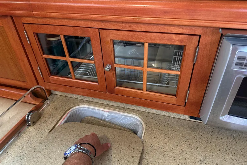 Dasananas Yacht Photos Pics Wooden kitchen cabinetry in a 2008 Hunter 49 yacht, featuring a countertop and sink.