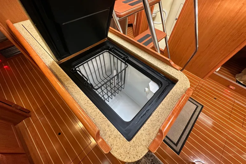 Dasananas Yacht Photos Pics Open hatch in 2008 Hunter 49 yacht interior, revealing storage compartment.