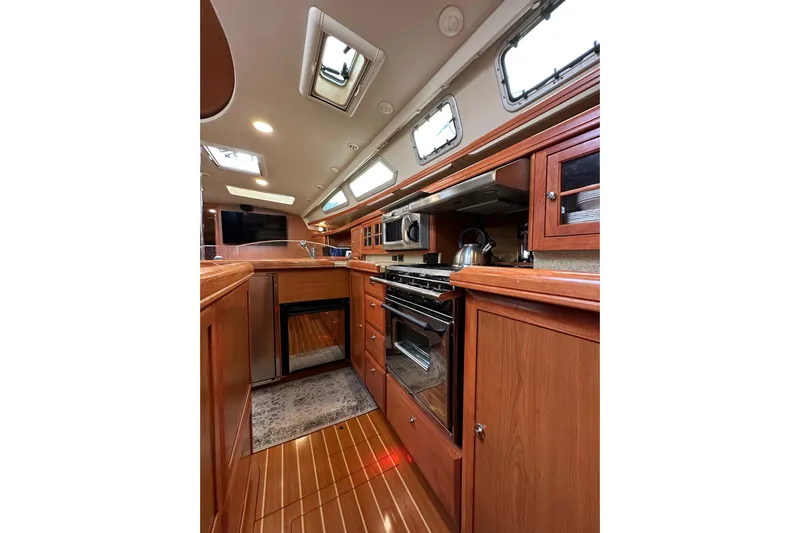 Dasananas Yacht Photos Pics Luxurious 2008 Hunter 49 yacht interior with modern kitchen and wooden cabinetry.