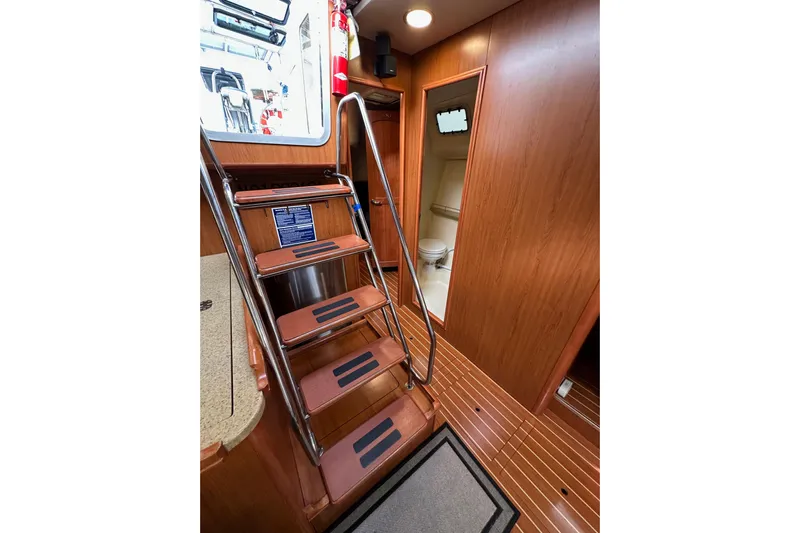Dasananas Yacht Photos Pics Interior of 2008 Hunter 49 yacht with wooden stairs and bathroom view.