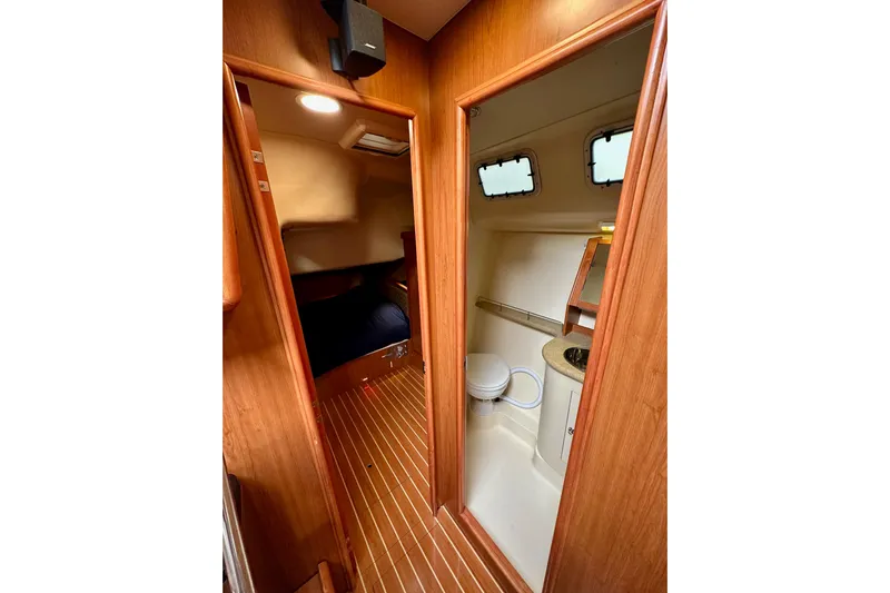 Dasananas Yacht Photos Pics Interior of 2008 Hunter 49 yacht showing cabin and bathroom with wooden finish.