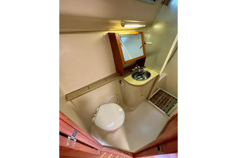 Dasananas Yacht Photos Pics Compact bathroom in 2008 Hunter 49 yacht with sink, toilet, and mirror.