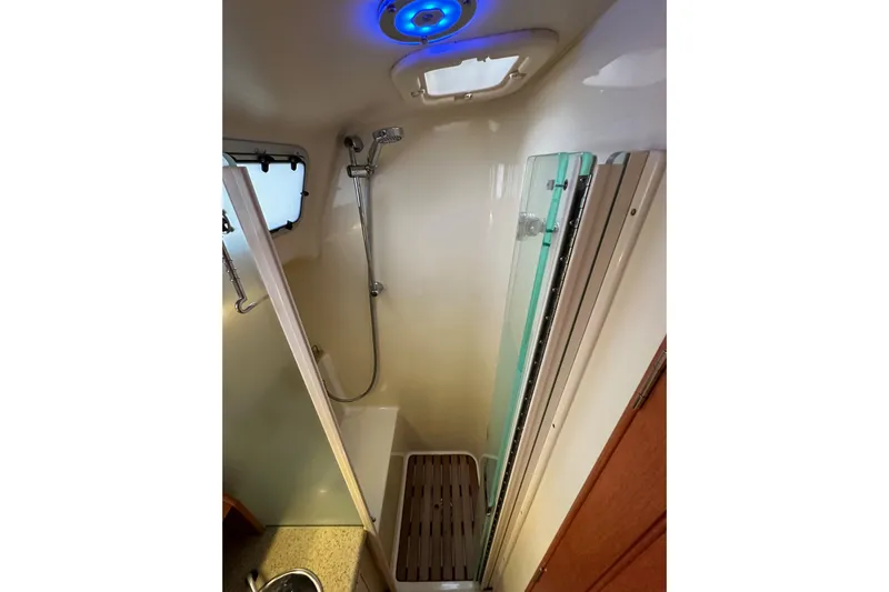 Dasananas Yacht Photos Pics Compact shower area in a 2008 Hunter 49 yacht with modern fixtures and blue lighting.