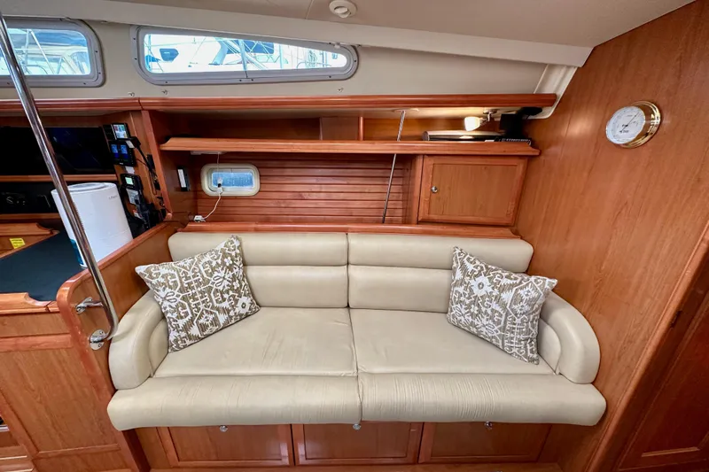 Dasananas Yacht Photos Pics Luxurious interior of 2008 Hunter 49 yacht with beige sofa and patterned cushions.