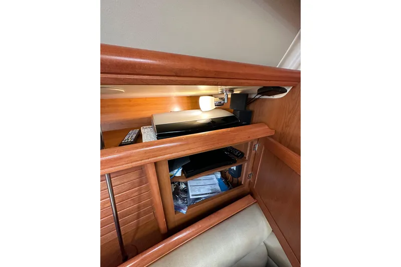Dasananas Yacht Photos Pics Interior of 2008 Hunter 49 yacht with wooden cabinetry and electronic equipment.