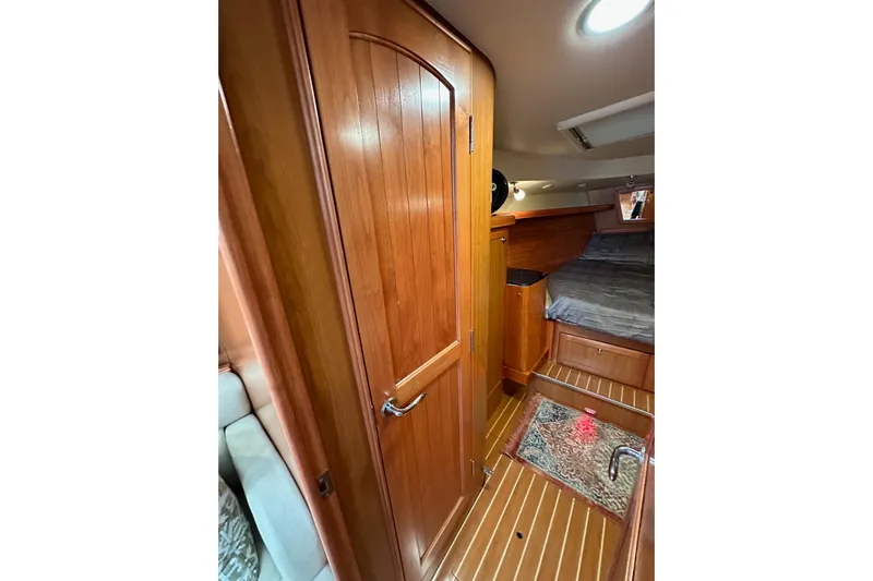 Dasananas Yacht Photos Pics Interior of 2008 Hunter 49 sailboat with wooden cabinetry and cozy sleeping area.