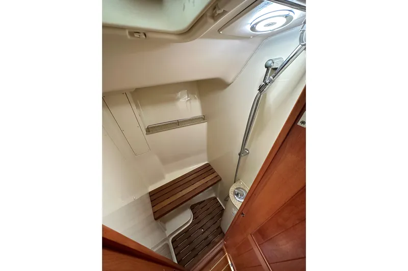 Dasananas Yacht Photos Pics Compact shower area in 2008 Hunter 49 yacht with wooden bench and handheld showerhead.