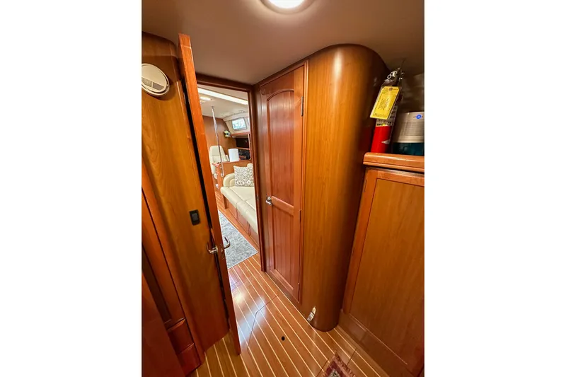 Dasananas Yacht Photos Pics Interior of 2008 Hunter 49 yacht with wooden cabinetry and cozy seating area.