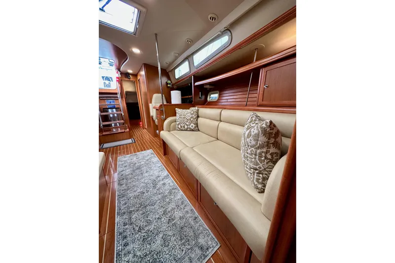 Dasananas Yacht Photos Pics Luxurious interior of 2008 Hunter 49 yacht with elegant seating and wooden finishes.