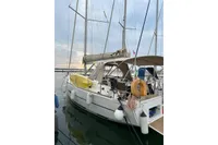 2020 Dufour 360 Grand Large sailboat docked at marina, featuring a spacious deck and equipment.
