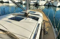2020 Dufour 360 Grand Large sailboat docked in marina, showcasing sleek deck design.