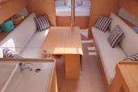 2020 Dufour 360 Grand Large yacht interior with cozy seating and striped cushions.