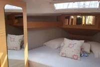 Cozy cabin interior of 2020 Dufour 360 Grand Large with decorative pillows and mirror.