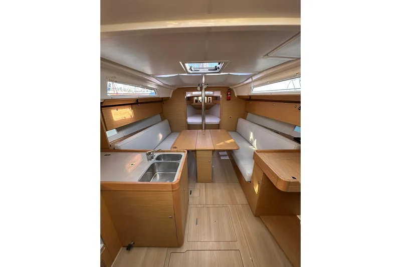  Yacht Photos Pics Interior of 2020 Dufour 360 Grand Large yacht, featuring modern wood finish and seating.