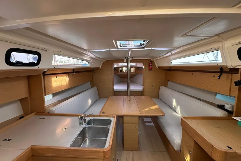  Yacht Photos Pics 2020 Dufour 360 Grand Large yacht interior with modern kitchen and seating area.