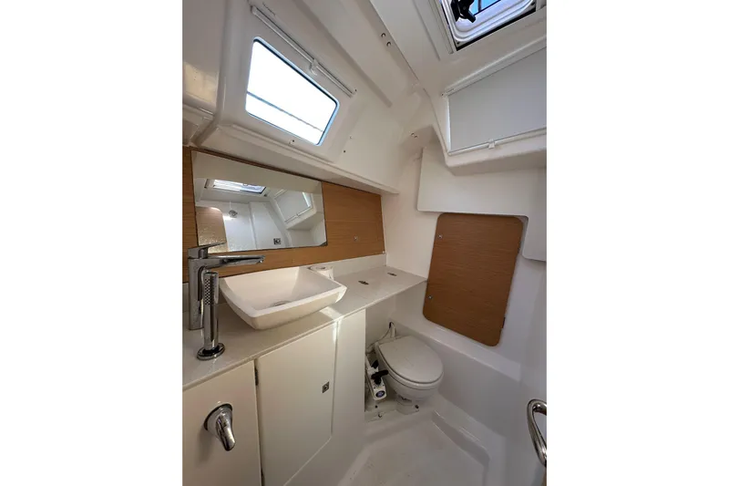  Yacht Photos Pics Modern bathroom in 2020 Dufour 360 Grand Large yacht with sink, toilet, and mirror.
