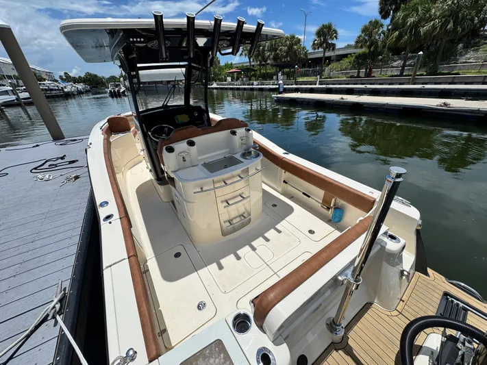  Yacht Photos Pics 2024 Scout 277 LXF boat docked, featuring spacious deck and modern amenities.