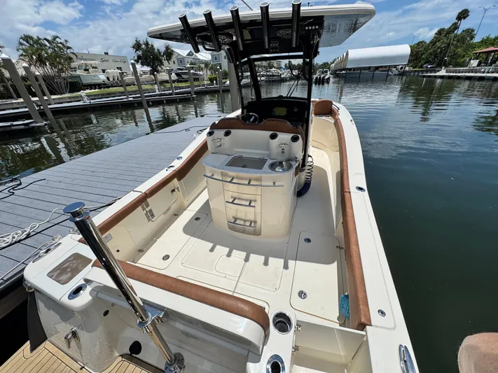  Yacht Photos Pics 2024 Scout 277 LXF boat docked, featuring spacious deck and modern amenities.