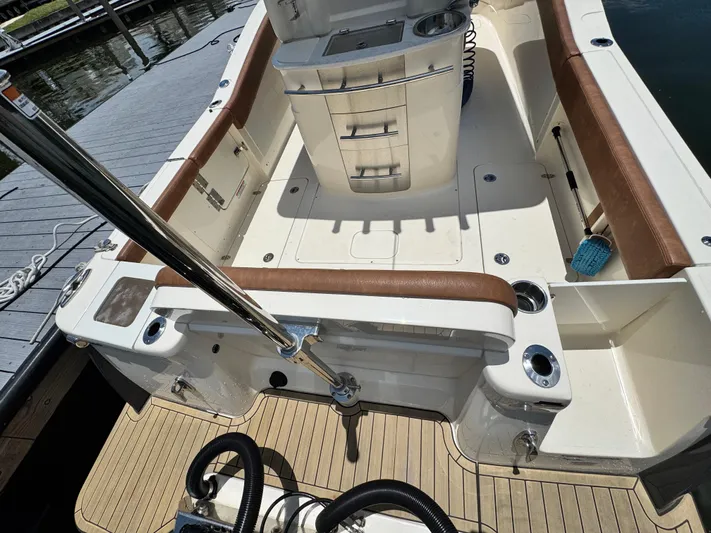  Yacht Photos Pics 2024 Scout 277 LXF boat interior with brown seating and fishing rod holders.