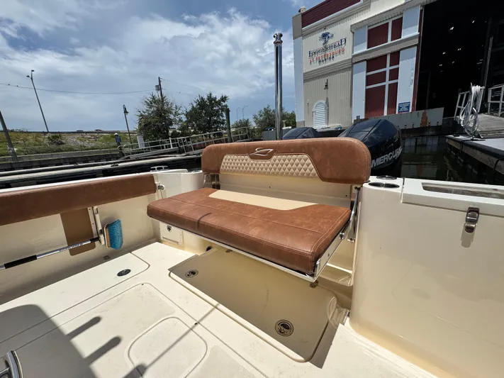  Yacht Photos Pics 2024 Scout 277 LXF boat with tan seating at a marina.