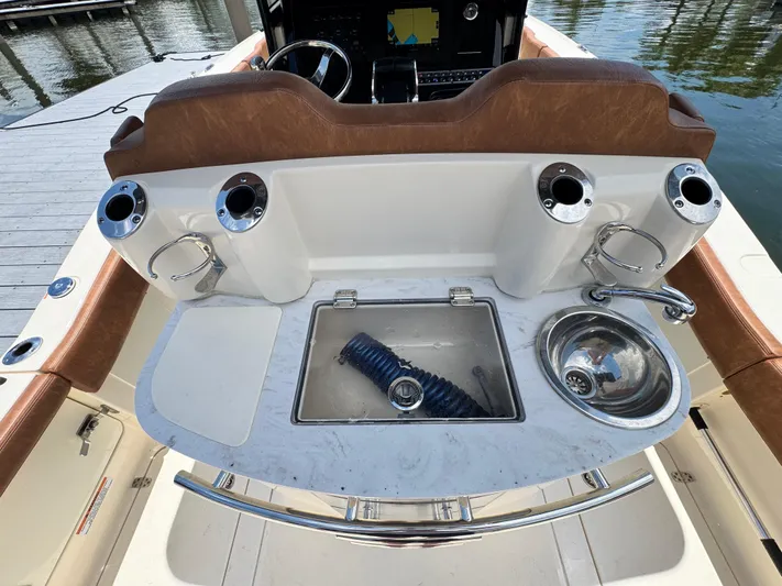  Yacht Photos Pics 2024 Scout 277 LXF boat interior with sink and storage area.