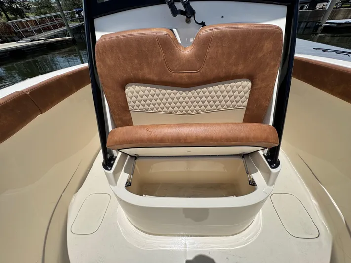  Yacht Photos Pics 2024 Scout 277 LXF boat interior with tan leather seating and storage compartment.