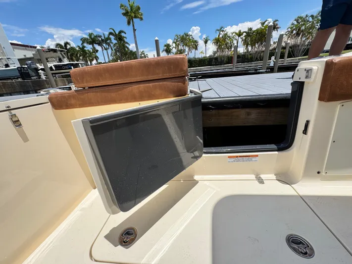  Yacht Photos Pics 2024 Scout 277 LXF boat with open side door, dockside view.