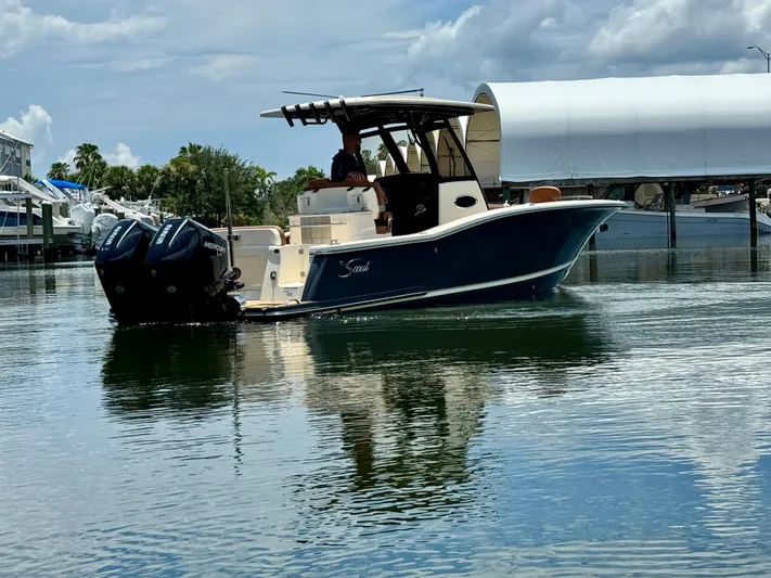  Yacht Photos Pics 2024 Scout 277 LXF boat on calm water with dual Mercury engines.