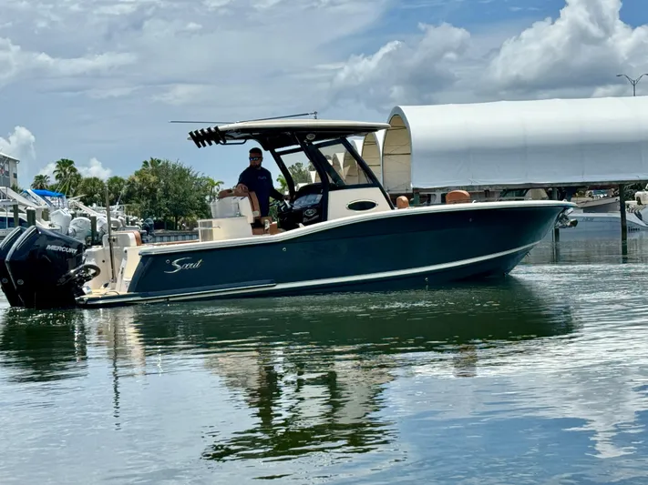 Yacht Photos Pics 2024 Scout 277 LXF boat on water, featuring sleek design and Mercury engines.