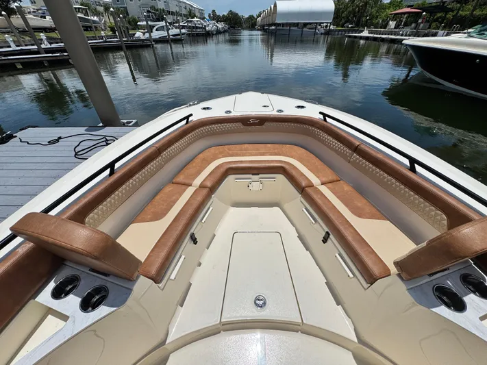  Yacht Photos Pics 2024 Scout 277 LXF boat with luxurious tan seating in a marina setting.
