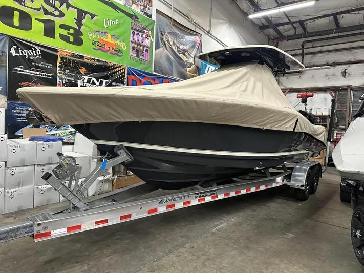  Yacht Photos Pics 2024 Scout 277 LXF boat covered on trailer in indoor storage.