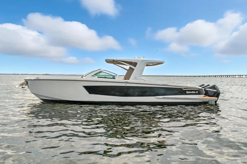  Yacht Photos Pics 2021 Aviara AV36 OB boat on calm water under a blue sky.