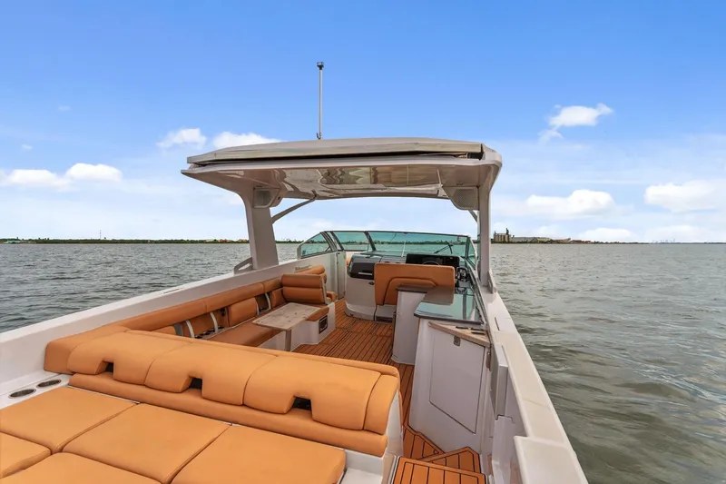  Yacht Photos Pics 2021 Aviara AV36 OB boat with tan seating, cruising on open water under a clear sky.