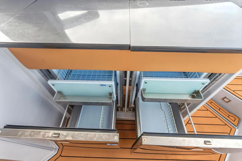  Yacht Photos Pics 2021 Aviara AV36 OB boat interior with open stainless steel drawers and wooden flooring.