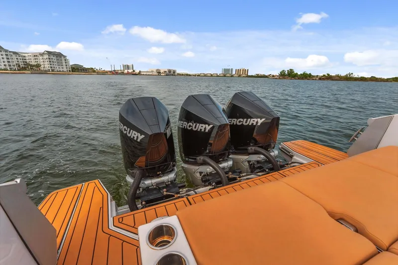  Yacht Photos Pics 2021 Aviara AV36 OB boat with triple Mercury outboard engines on a scenic waterfront.